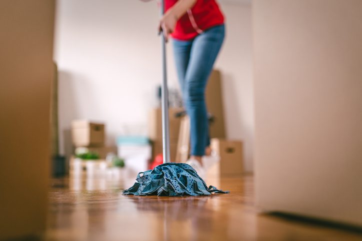 Beautiful single lady cleaning her new apartment.